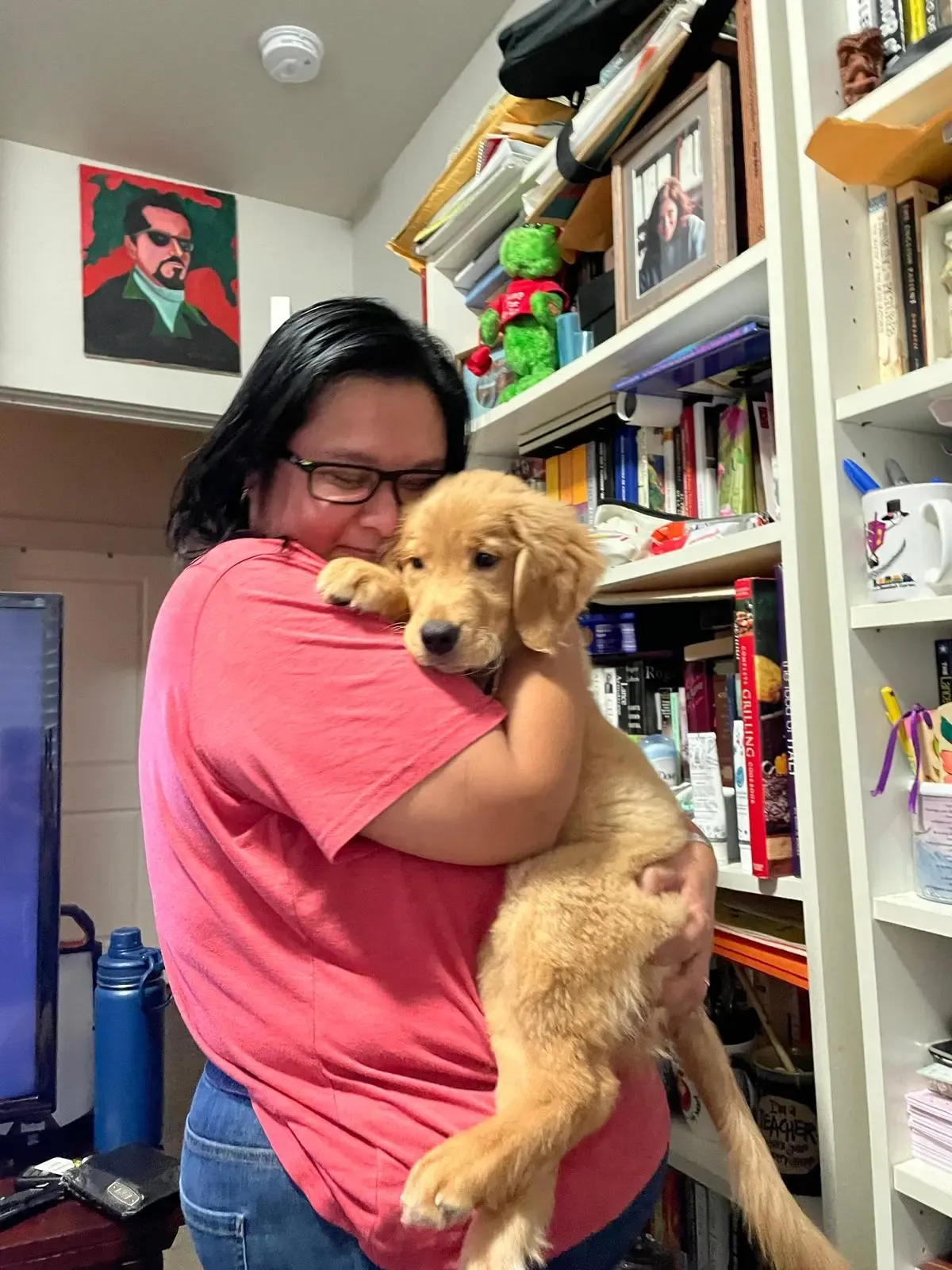 A member of the Davis family hugging Nala as a puppy